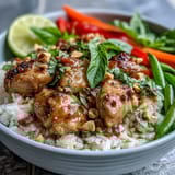 Fragrant Thai Chicken Coconut Bowl with fluffy coconut rice, juicy chicken, and crisp, fresh vegetables topped with chopped peanuts.