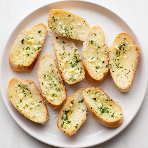 Crispy Garlic Bread topped with melted Parmesan, fresh parsley, and a side of marinara dipping sauce.
