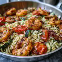 Vibrant one-pan lemon butter shrimp and orzo with juicy shrimp, tender pasta, and fresh vegetables in a zesty, savory sauce.
